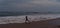 Boy running in dusk on seashore