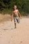 Boy running on dusty road