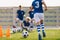 Boy Running on Grass Field in Soccer Cleats. Closeup image on Football Shoes