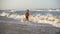 Boy running at the sea surf