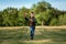 A boy runs across the field and launches a toy airplane against the backdrop of greenery. The concept of dreams, choice of