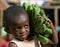 The boy\'s portrait with a linking of bananas who goes to the market them to sell.