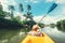 Boy sailing in canoe boat on tropical lagoon