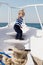 Boy sailor striped shirt sea yacht travel around world. Little sea traveller. Beach is calling and we must go. Baby boy