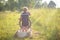 Boy in sailor suit playing in boat on grass