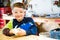 Boy sanding wooden block in workshop