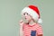 Boy in santa hat and glasses threatens finger