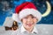 Boy in santa hat smiling at camera