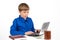 Boy schoolboy in a blue T-shirt preparing for school, studying business, finance: in front of him is a laptop, notebook, pencil