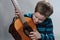 Boy schools himself to play the  acoustic guitar