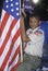 Boy Scout with an American flag at the Clinton/Gore 1992 Buscapade campaign tour in Tyler, Texas