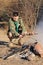 Boy Scout Cooking Sausages on Stick over Campfire