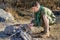 Boy Scout Cooking Sausages on Sticks over Campfire