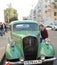 Boy scrutinize cabin of the retro car 1930s Opel Super