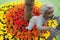 A boy sculpture among red and yellow flowers at Princess Maha Chakri Sirindhon Herbal Garden - Rayong, Thailand