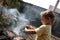 Boy seasoning pork chops with pepper