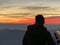 A boy seen from the back looking to the sunset from Uetliberg Zurich Switzerland.