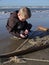 Boy selecting shrimp catch on the beach