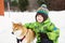 Boy with Shiba Inu dog outdoors in the winter