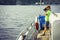 Boy on the ship photographing water