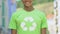 Boy in shirt with recycle sign smiling into camera, promoting reusable products