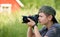 Boy shooting nature with SLR camera