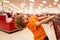 A boy is shopping in a supermarket. Funny child with shopping trolley with in grocery store.