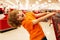 A boy is shopping in a supermarket. Funny child with shopping trolley with in grocery store.