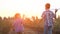 Boy siblings run past fields to launch airplanes to sky