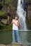 Boy singing at waterfall