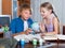 Boy and sister studying with books