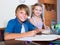 Boy and sister studying with books