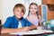 Boy and sister studying with books