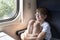 Boy sits in compartment carriage and hugs his knees. Travel by railway
