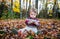 Boy Sits Inspecting a Maple Leaf