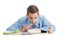 Boy sits near the desk with school supplies isolated on white background