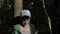 Boy sits under a tree and reads a book with charts outdoors