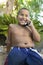 Boy sitting in back yard Using Cell Phone front view