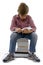 Boy sitting on books on white background