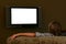 Boy sitting on couch watching widescreen television