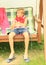 Boy sitting on a garden swing