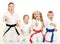 A boy sitting with his sister and mom with her daughter in a ritual pose karate and beat his fist