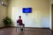 A boy sitting in a room in front of the monitor