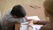 Boy sitting in silence during session with young psychologist. holding the hand