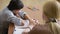 Boy sitting in silence during session with young psychologist. holding the hand