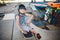 Boy sitting at skatepark, looking camera. Kid resting with skate board at skate park. child sits on ramp resting after training on