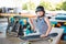 Boy sitting at skatepark, looking camera. Kid resting with skate board at skate park. child sits on ramp resting after training on