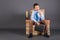 A boy sitting on a throne from books