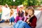 Boy with skateboard and his friends sitting behind