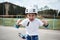 Boy skateboarder in safety helmet screaming and showing fists looking at camera
